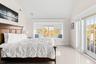 Bedroom featuring lofted ceiling and access to outside