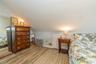 Bedroom featuring wood-type flooring and vaulted ceiling