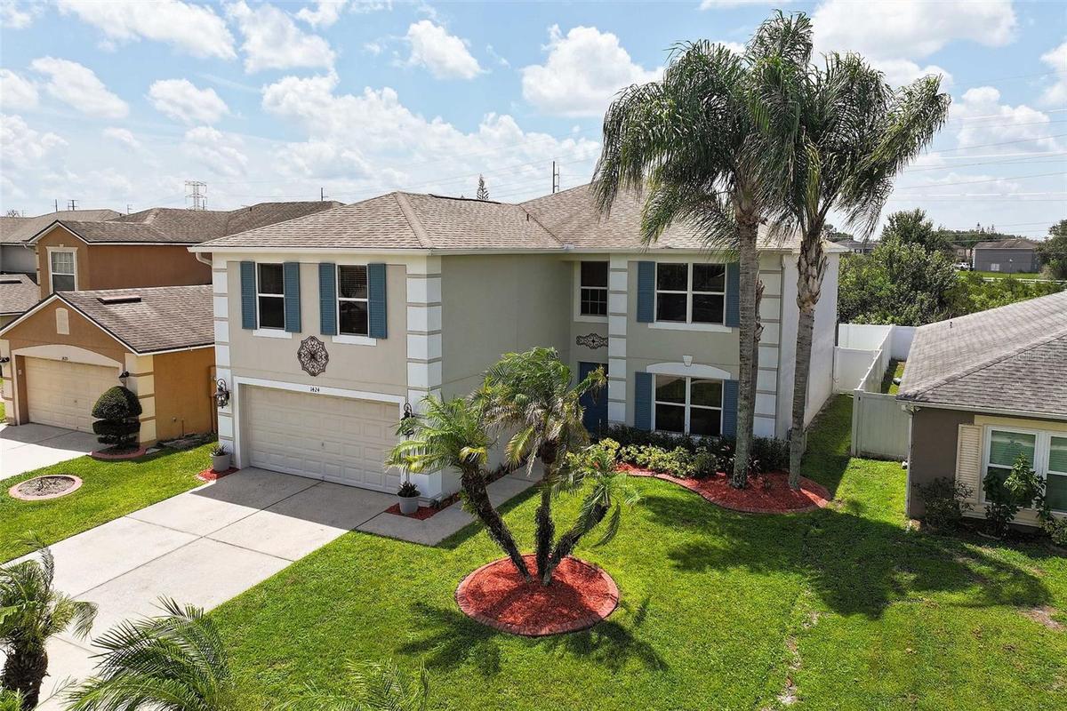 Front Side Exterior with home's mature landscaping
