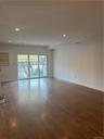 Another view of the Living Room leading to the expansive Trex Deck. You'll marvel at these sumptuous, walnut stained, hardwood floors! This is a view 