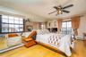 Bedroom featuring a baseboard radiator and wood finished floors