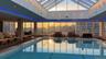 Indoor community pool with a patio area