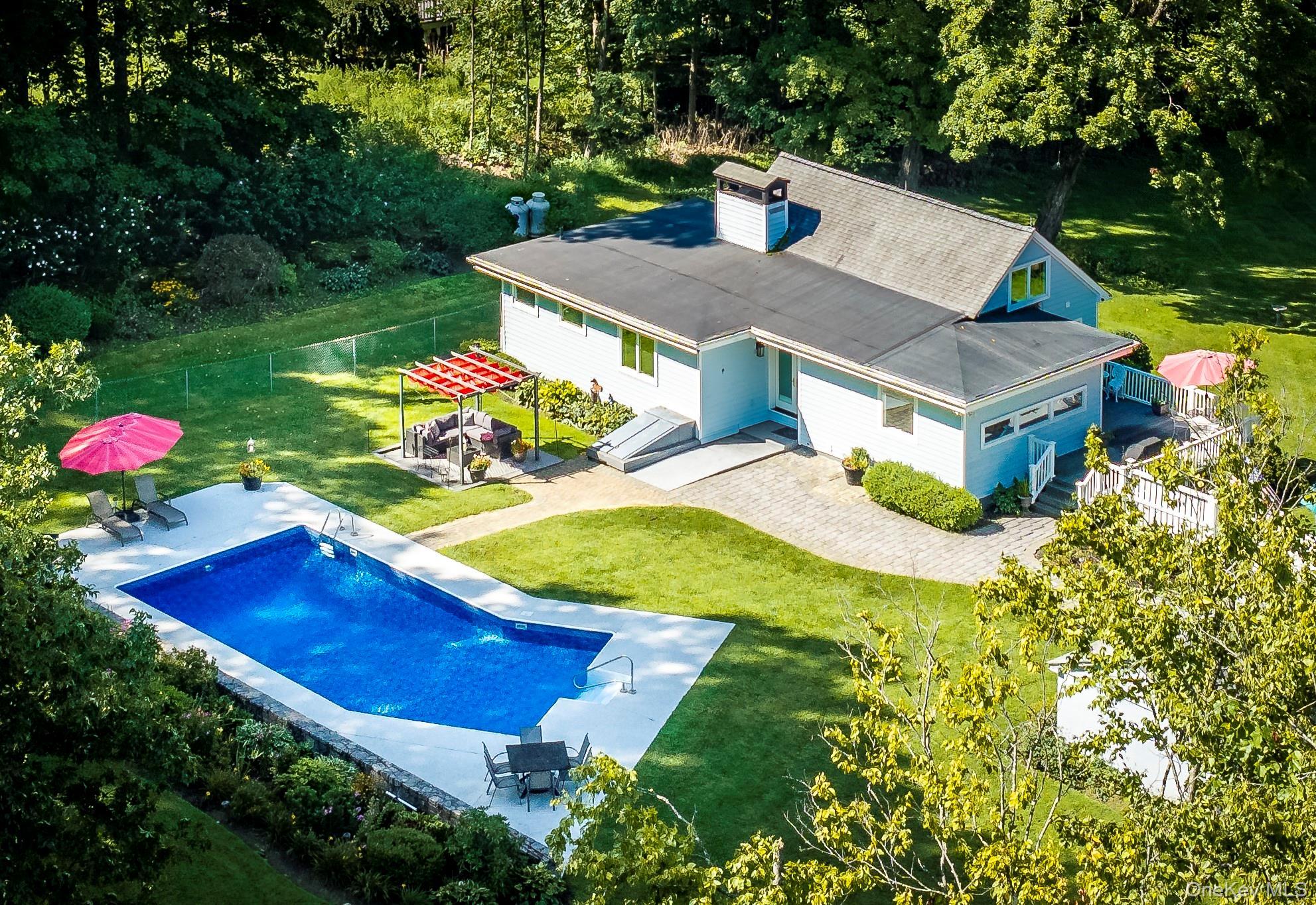 Set on over an acre and a half of pure enchantment, this charming predominantly one-level ranch-style home offers thoughtfully designed living space i