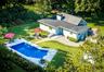 Set on over an acre and a half of pure enchantment, this charming predominantly one-level ranch-style home offers thoughtfully designed living space i