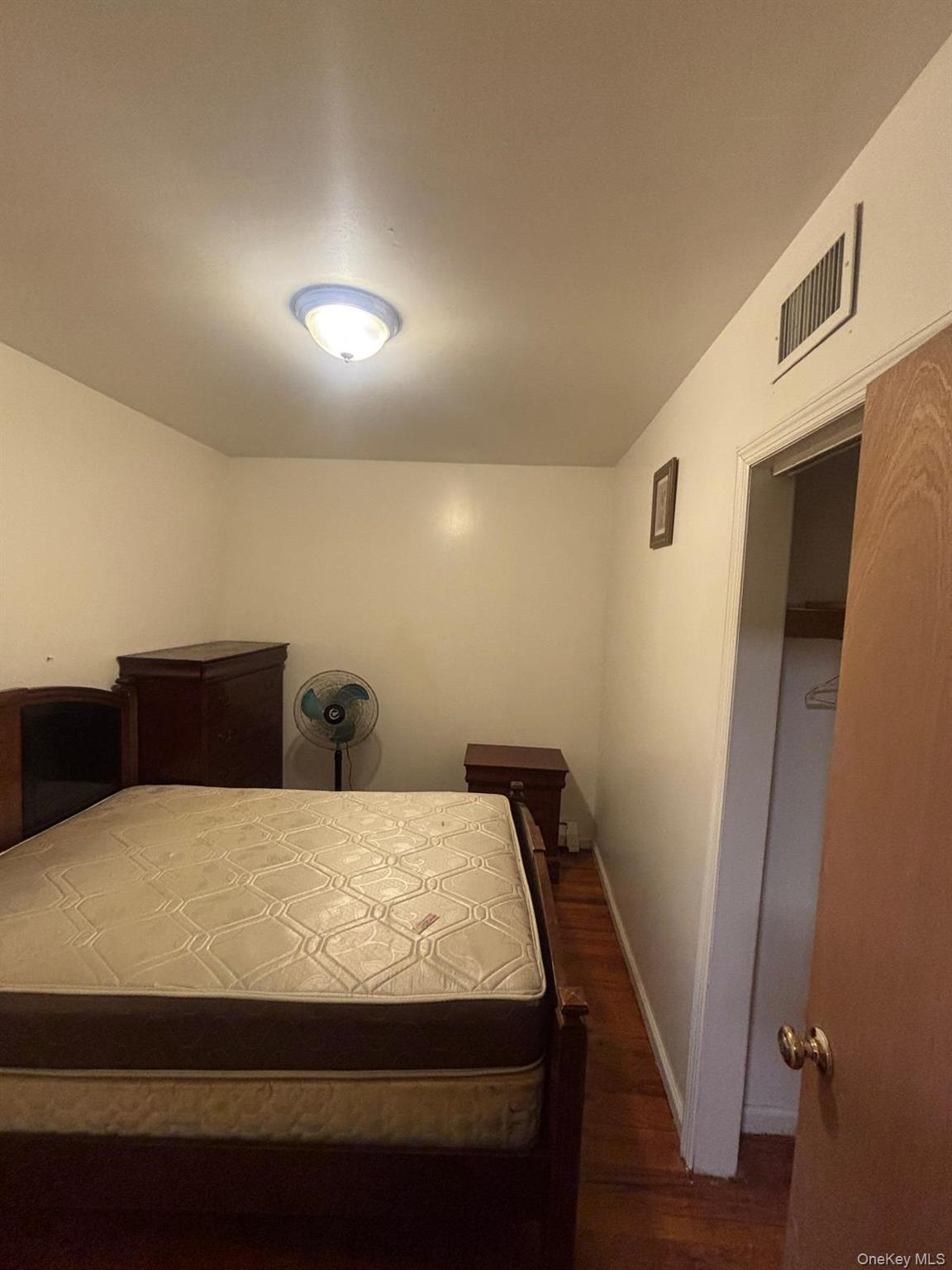 Bedroom featuring baseboards and dark wood-style flooring