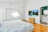 Bedroom with high vaulted ceiling, sink, light hardwood / wood-style floors, ensuite bath, and a closet