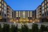 A captivating twilight shot showcases the building's front facade glowing warmly as day transitions to night.
