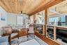 Interior featuring wood-finish ceiling, hardwood flooring, built-in shelving.