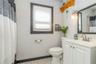 !ST floor Bathroom featuring curtained shower, vanity, and toilet