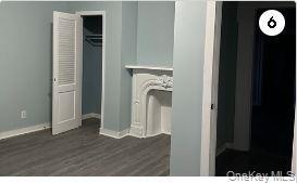 Laundry area with baseboards and dark wood finished floors