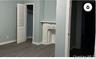 Laundry area with baseboards and dark wood finished floors