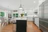 Chef's kitchen with new SS appliances and pendant lighting