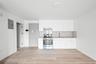 Kitchen featuring stainless steel electric range oven, electric panel, white cabinetry, light wood-type flooring, and tasteful backsplash