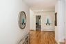 Hall with light wood-style flooring, a baseboard radiator, and recessed lighting