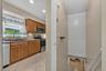 Stairway off the kitchen leads to the spacious lower-level family room and additional living space.