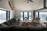 Living room featuring a water view, lofted ceiling, and a ceiling fan