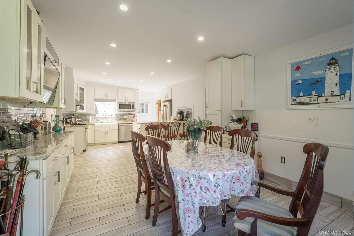 Fully updated with new tile floors, kitchen cabinets with quartz countertops and stainless steel appliances makes this a kitchen you want to spend tim