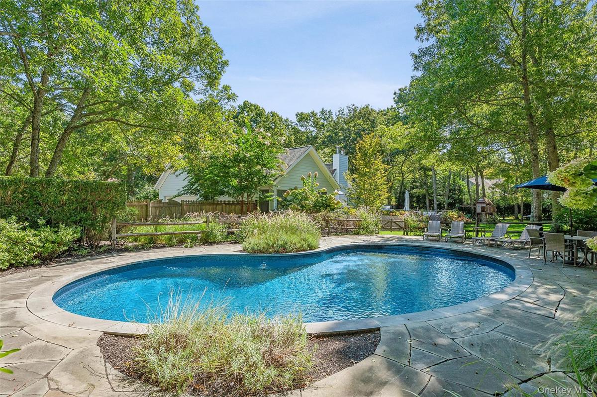 View of swimming pool featuring fence, a patio, and a fenced in pool