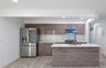 Kitchen with stainless steel appliances, tasteful backsplash, light stone countertops, recessed lighting, and modern cabinets
