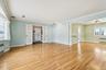 Unfurnished room with french doors, light wood-type flooring, ornamental molding, and radiator