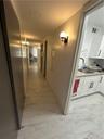 Hallway featuring sink and light tile floors