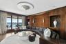 Living area featuring wood walls, a water view, and wood finished floors