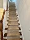 This home features 3 beautiful staircases. This one goes up from the main level to the 3rd floor bedrooms.