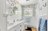 Full bathroom with toilet, vanity, shower / bath combo, tile patterned flooring, and a baseboard heating unit