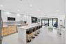 WOW! Beautiful porcelain flooring, huge center island w/ waterfall quartz counter & counter seating.