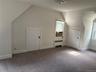 Additional living space featuring vaulted ceiling, radiator, carpet floors, and cooling unit