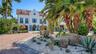 Grand arrival framed by tropical landscaping