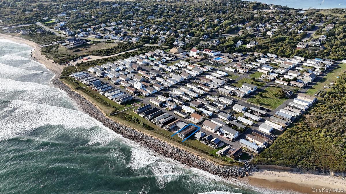 View of property location with expansive beach and nearby suburban area