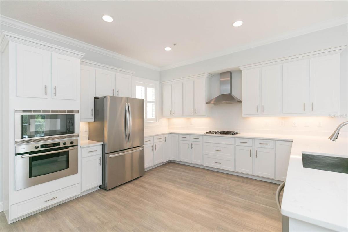 Upgraded appliances, quartz counters, wood cabinetry...