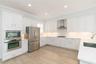 Upgraded appliances, quartz counters, wood cabinetry...