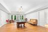 Game room featuring light wood-type flooring and a tray ceiling