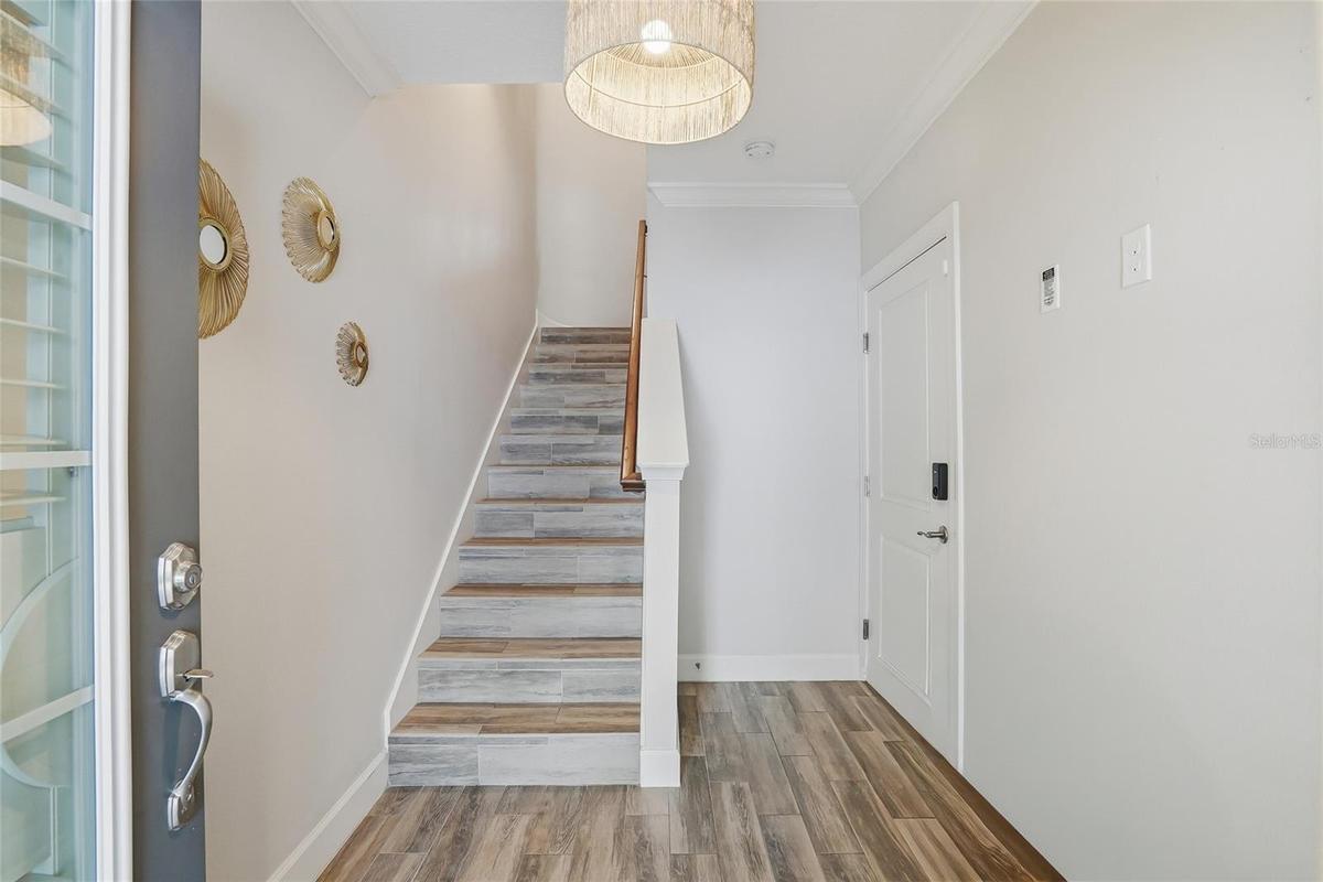 First floor foyer. To the right is the door to the expansive two-car garage and elevator.