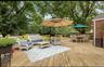 Deck with outdoor dining area, an outdoor living space, and view of wooded area