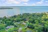 Aerial view of residential area featuring property parcel outlined and a large body of water
