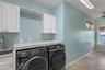 Adjacent to the Library is the Laundry Room and intimate Office Space w/ View of River