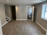 Empty room with wood tiled floors, recessed lighting, and stairway