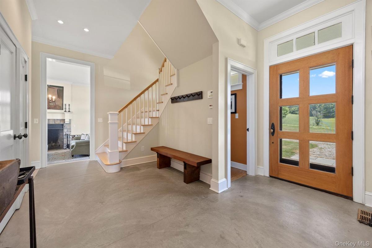 A Stunning Entrance with Polished Concrete Floor, Pegs to Hang Coats & Closets