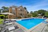 View of swimming pool with a patio area, a storage structure, an outdoor kitchen, and an outbuilding