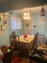 Dining space with wood finished floors and a chandelier