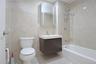 Bathroom with vanity, tile walls, and shower combination