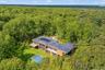 View from above of property featuring a heavily wooded area
