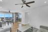 Living room with recessed lighting, light wood-style flooring, a ceiling fan, and a water view