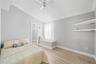 2nd bedroom with vaulted ceiling, built in shelves and storage box