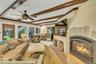 Southwest facing great room oozing with natural light, featuring beam ceiling, recessed lighting, french doors to den and back door leading to brick p