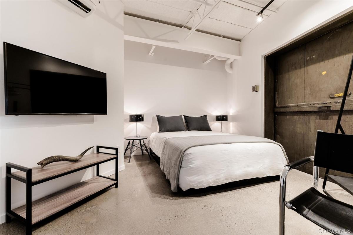 Bedroom featuring a wall unit AC
