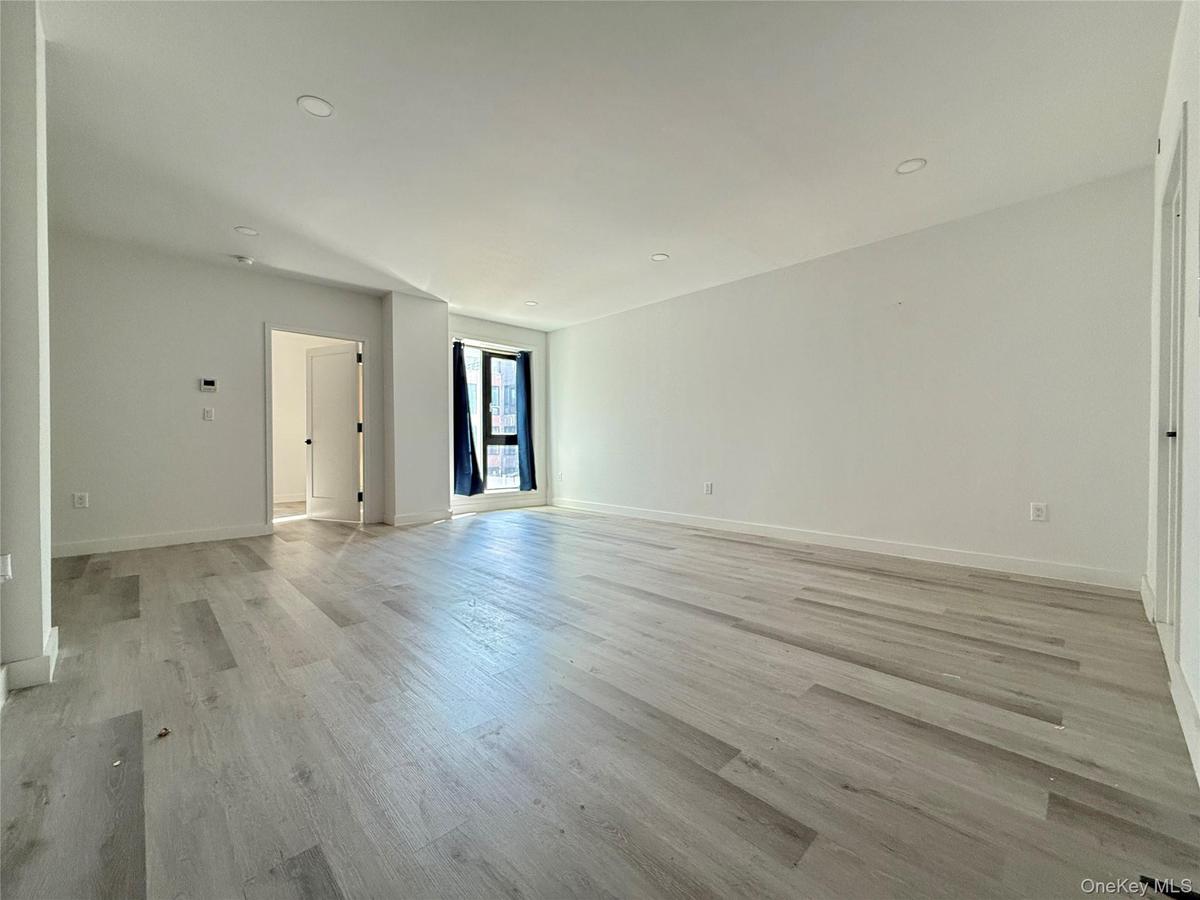 Spare room with light wood-style floors and recessed lighting